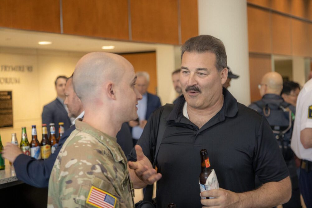 Charles Guddemi conversing with interoperability institute 2024 attendee