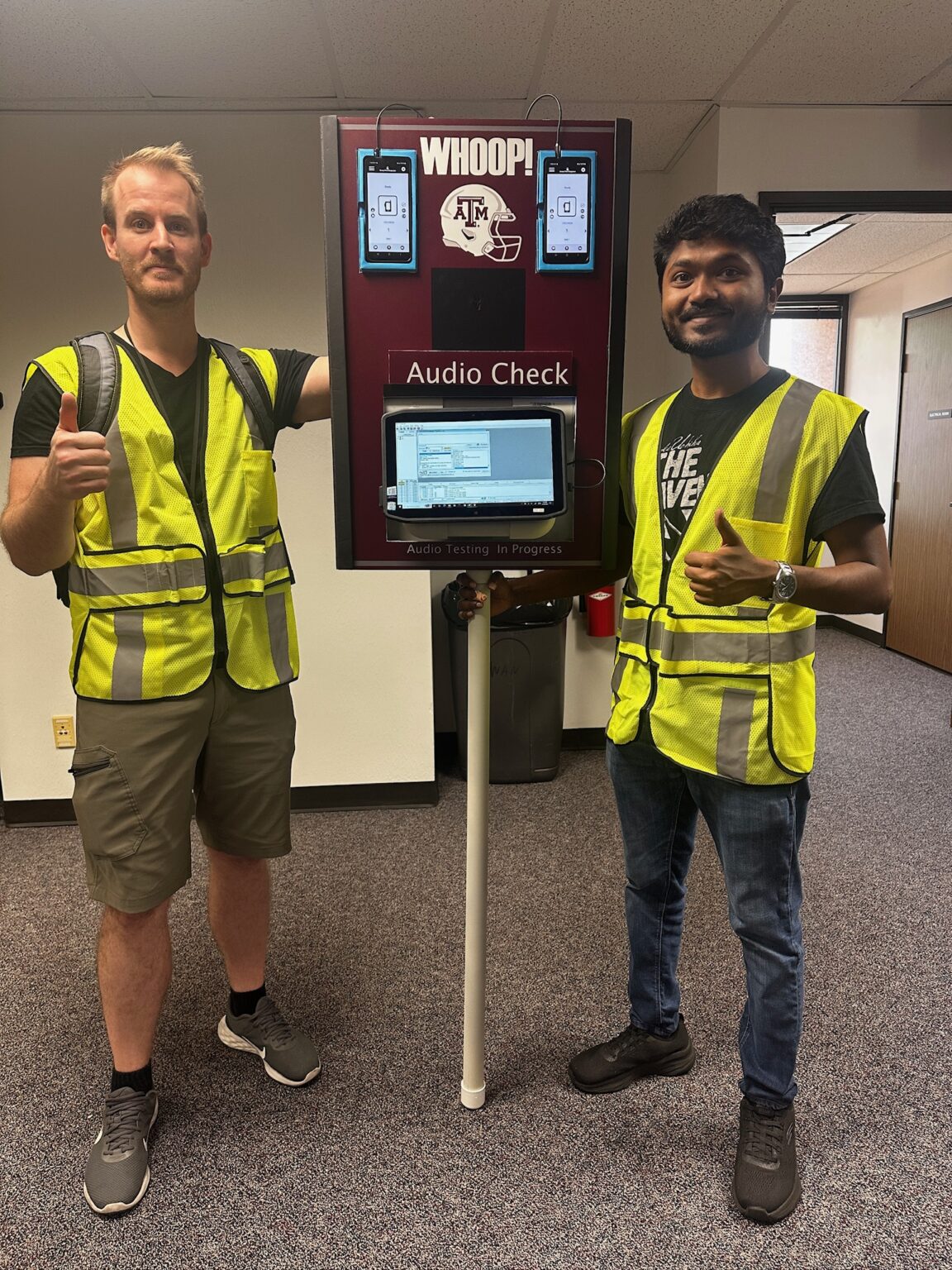 Derek Ladd and student assistant running network test at Kyle Field
