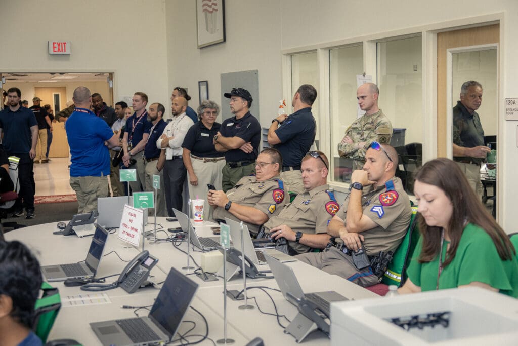 Public safety professionals sitting and standing in a safety exercise.