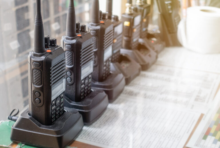 row of walkie talkies on table