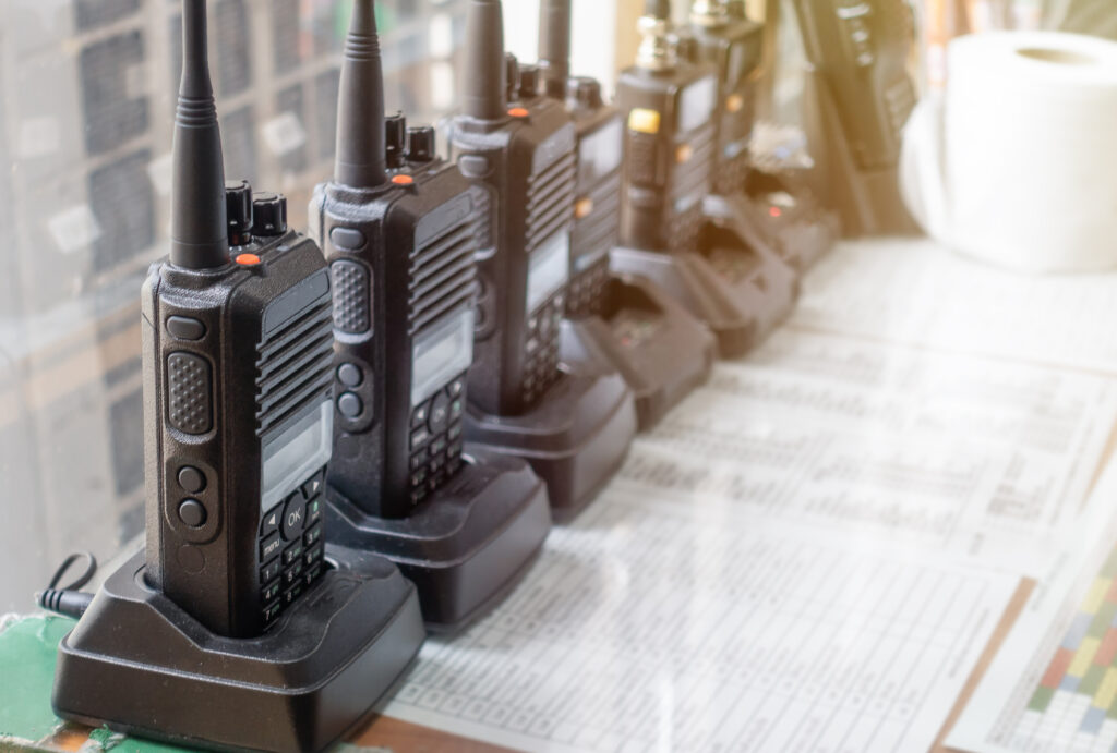 row of walkie talkies on table