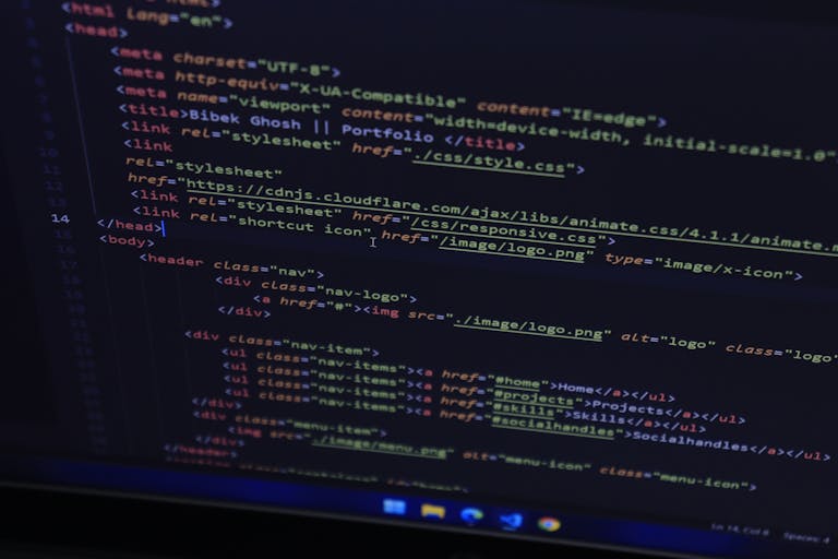 High-resolution close-up of HTML code displayed on a computer screen, perfect for technology themes.